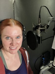 Kate smiles out from her Voiceover booth