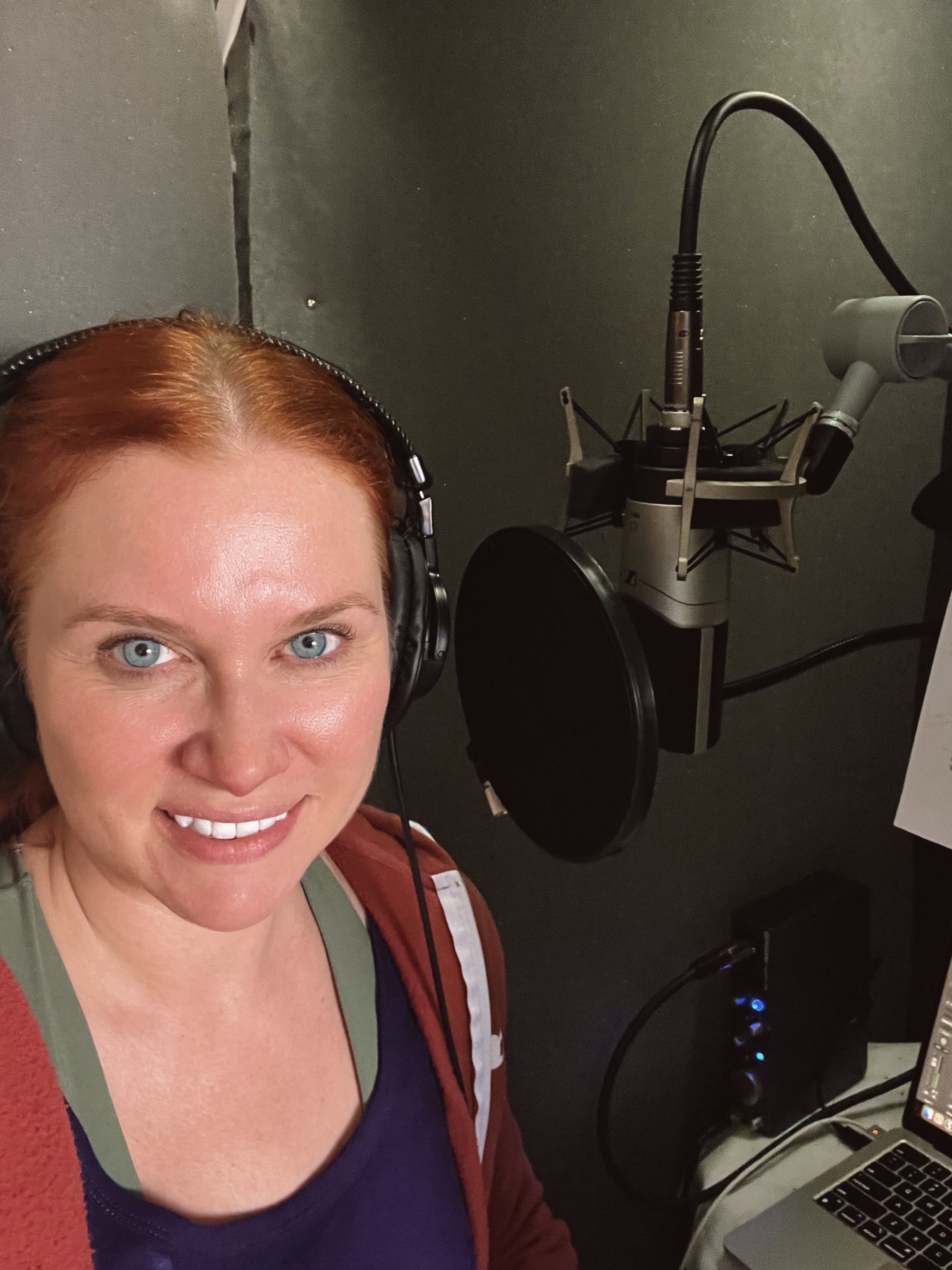 Kate smiles out from her VoiceOver booth, announcing her commercial voiceover demo